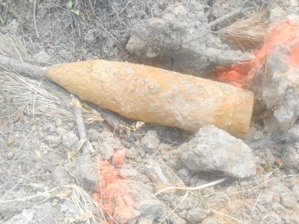 mortar round laying in dirt
