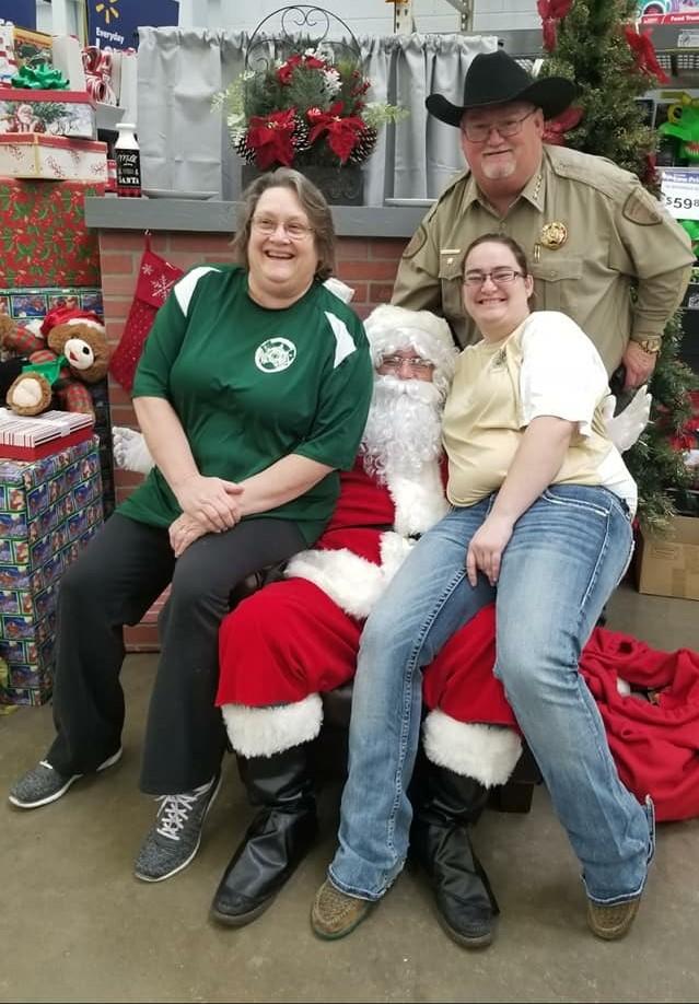 Sheriff Singleton with Santa and two women
