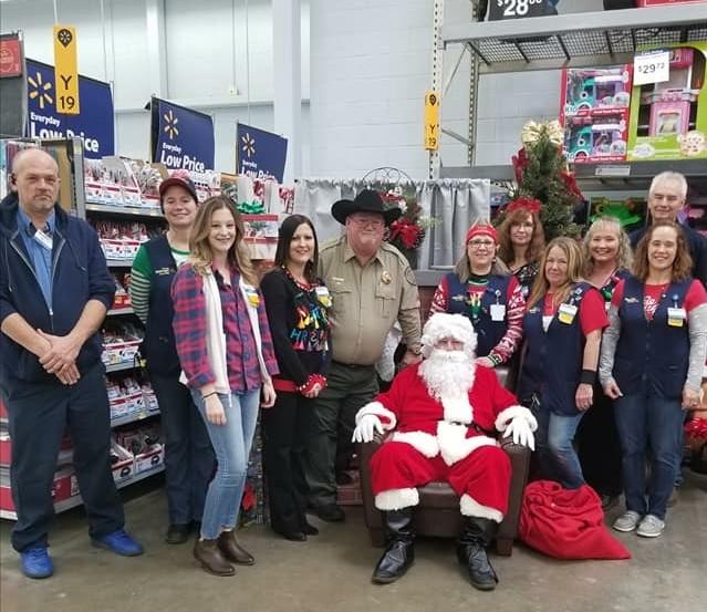 Sheriff and employees with Santa at Walmart