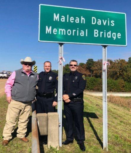 Officers with the Maleah Davis Memorial Bridge Sign