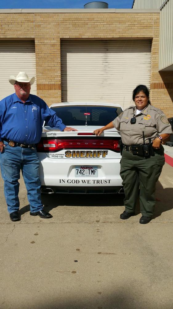 Sheriff Singleton & Deputy Billings standing with a car