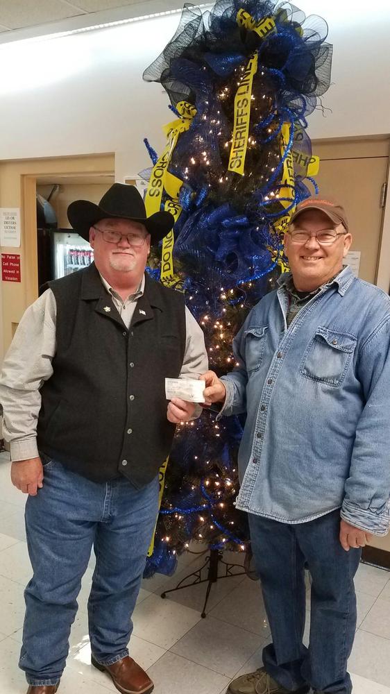 Howard Tippitt presenting a $500.00 check to Sheriff James Singleton