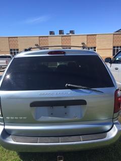 rear view of light blue Dodge Caravan