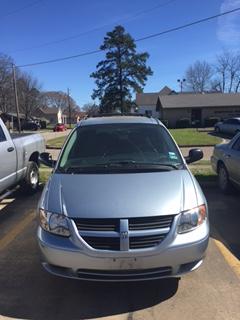 Front view of light blue Dodge caravan