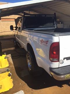 left rear side view of white 4x4 truck