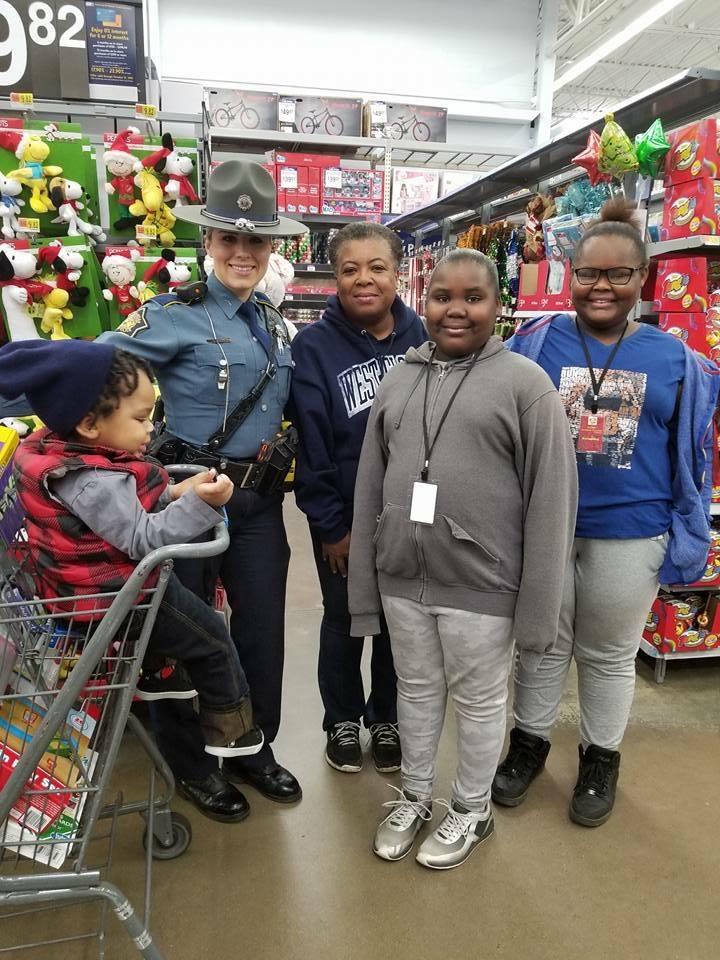 Law Enforcement officer shopping with a family in Walmart