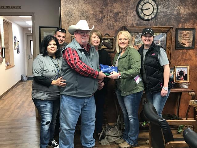Sheriff's Office staff presenting Jessica Oller with funds raised at benefit