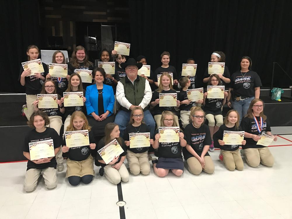 Sheriff Singleton with 5th graders graduating the DARE program