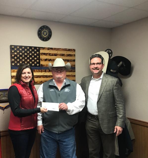 Sheriff Singleton presenting check to Ben and Jamie Gresham